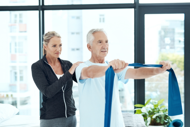 Elderly man exercising with resistance band to manage arthritis