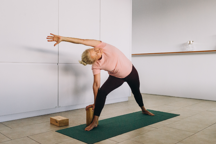 Senior woman practicing balance yoga pose for fall prevention